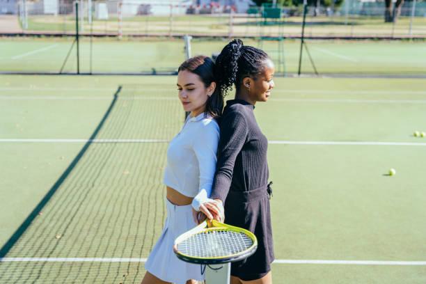 istock Two multiethnic females competitors preparing for a tennis game 2193257762
