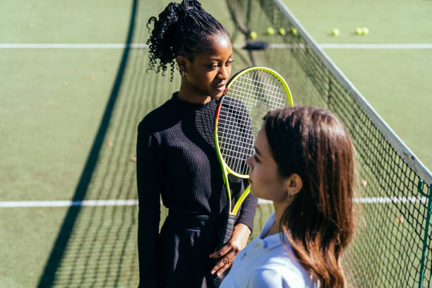 istock Two woman play tennis with net for match 2193257769