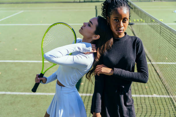 istock Two multiethnic females competitors preparing for a tennis game 2193257777