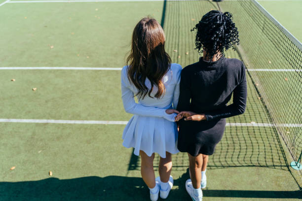 istock two multiethnic female tennis player in black and white activewear 2193257788