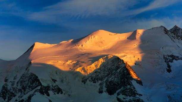 istock Snow-capped mountains illuminated by the sun 2193257997