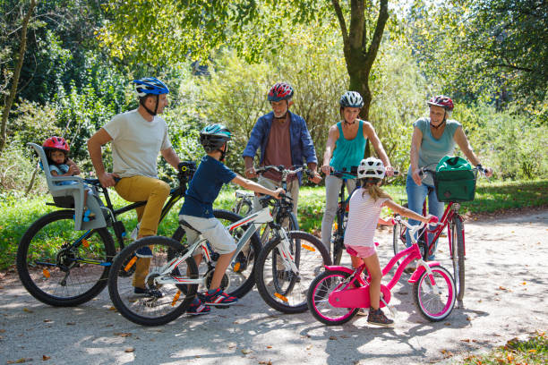istock Full family on bikes in a green park 2193259252