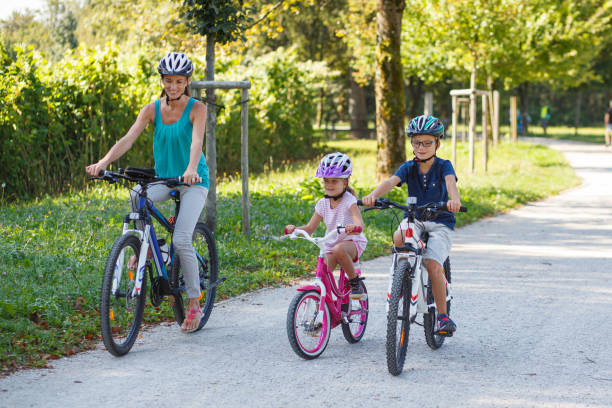istock Mother with two children on a bicycle trip 2193259383