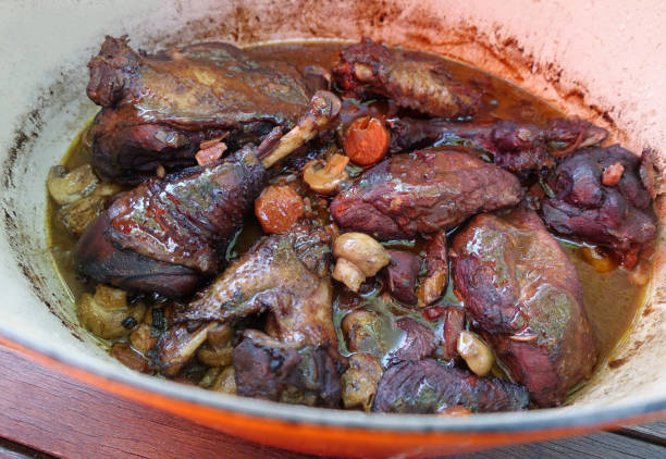 istock Coq au vin cooked in a casserole dish previously marinated in a spicy and flavored red wine sauce  
 Rooster cooked in red wine  French gourmet cuisine 2193259495