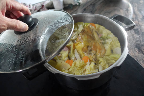 istock Chicken in a pot cooked in a spicy and flavored mixed vegetable broth  Chef checking cooking 2193259549