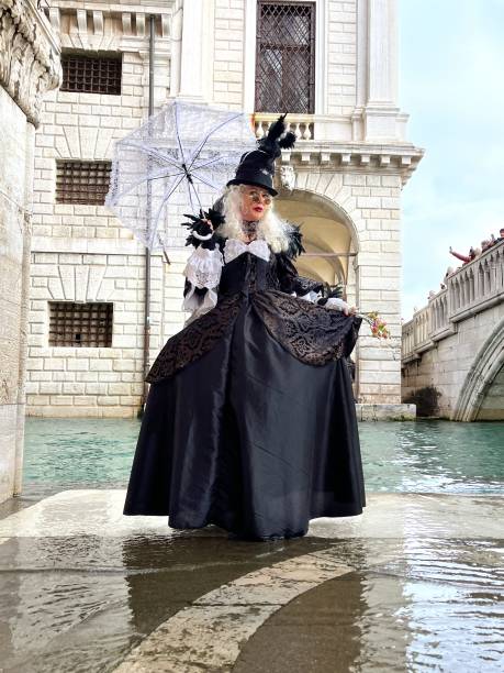 Annecy, France, March 16, 2014:  Portrait of a disguised person, posing in Annecy, France, during a Venetian Carnival which celebrates the beauty of the real Venice.