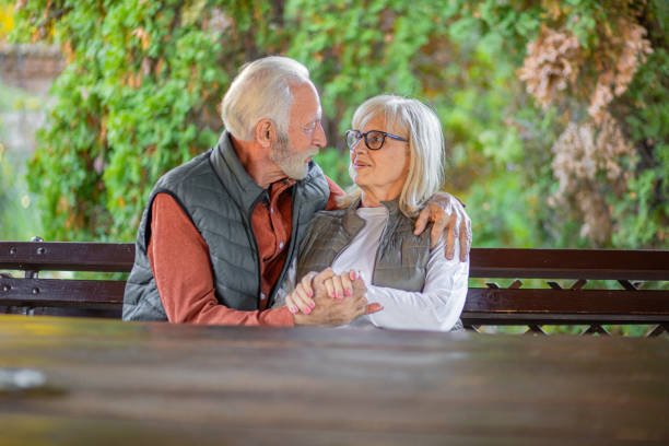 Senior couple eating snack at picnic