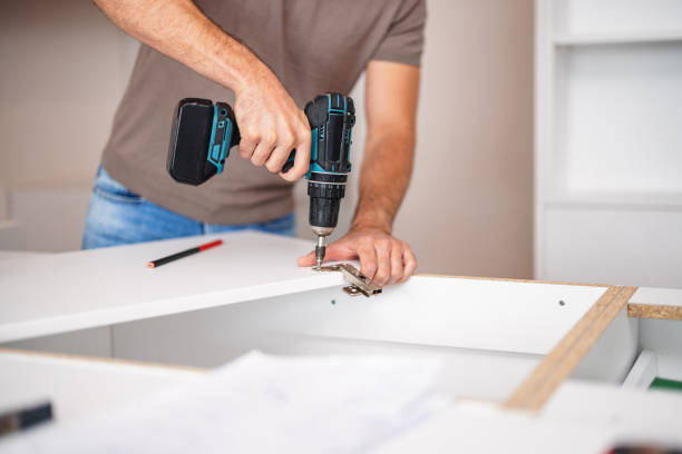 istock Carpenter Installing a Kitchen Cabinet in New Apartment 2193263145