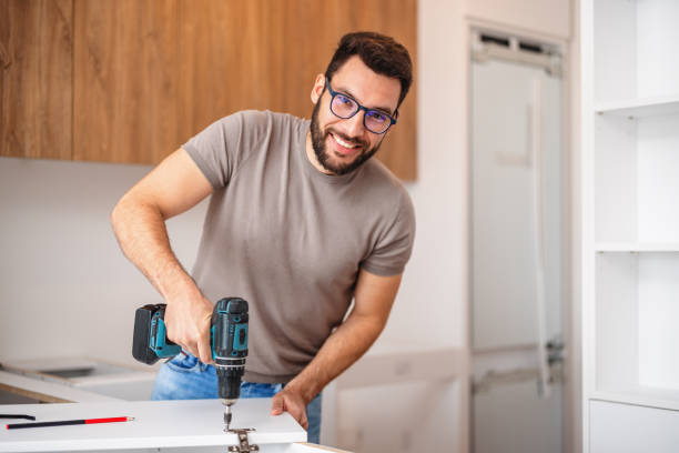 istock Carpenter Fitting a Kitchen Cabinet in New Apartment 2193263146