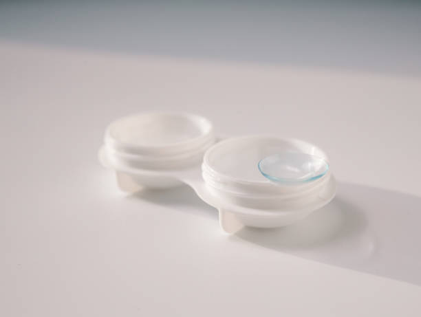 istock White contact lens case with a transparent lens on one side, placed on a clean white background. Minimalist design representing vision correction, hygiene, and eye care essentials 2193264763