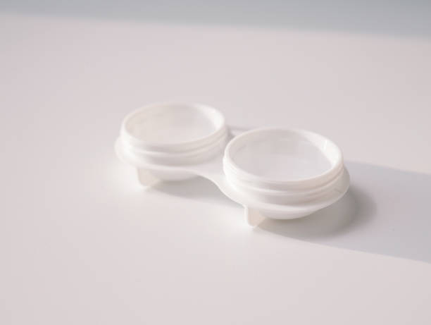 istock White contact lens case with a transparent lens on one side, placed on a clean white background. Minimalist design representing vision correction, hygiene, and eye care essentials 2193264766