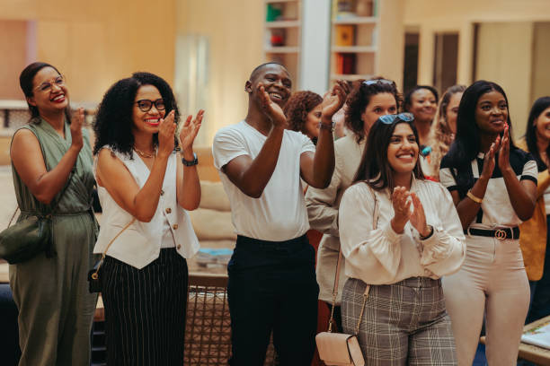 Happy employees applauding in office