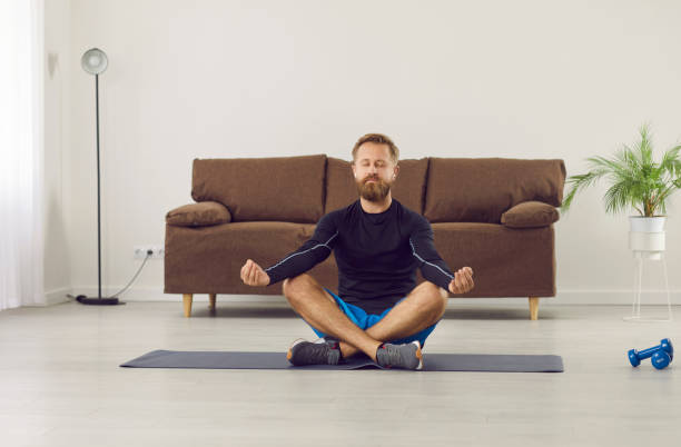 istock Calm man practice yoga meditate at home 2193265603