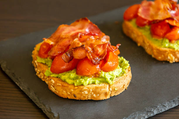 istock Avocado Toast with Tomatoes and Crispy Bacon Close-Up 2193266598