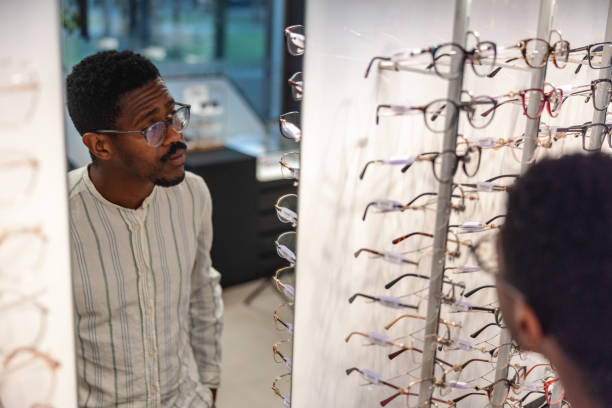 istock Mature Man Selecting Eyeglasses In An Optical Store 2193266679