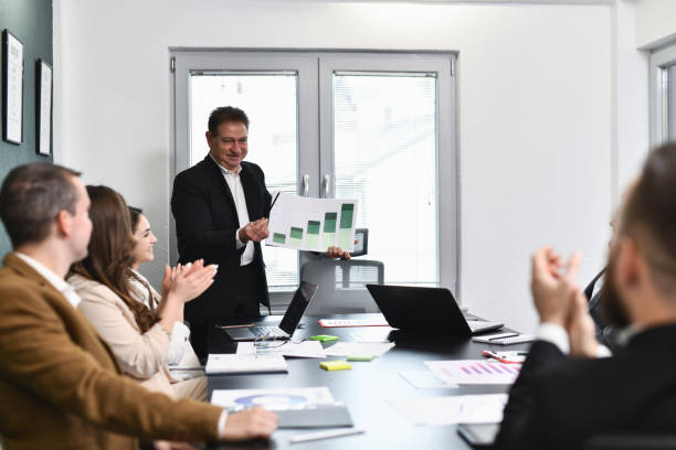 istock Happy Employees Clapping While Manager is Praising Their Success Showing Growth on Chart 2193267162