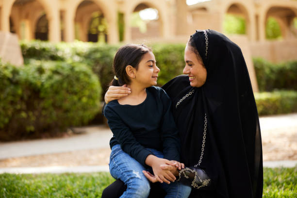 istock A mother and daughter smile at each other while having a conversation in the park. 2193267728