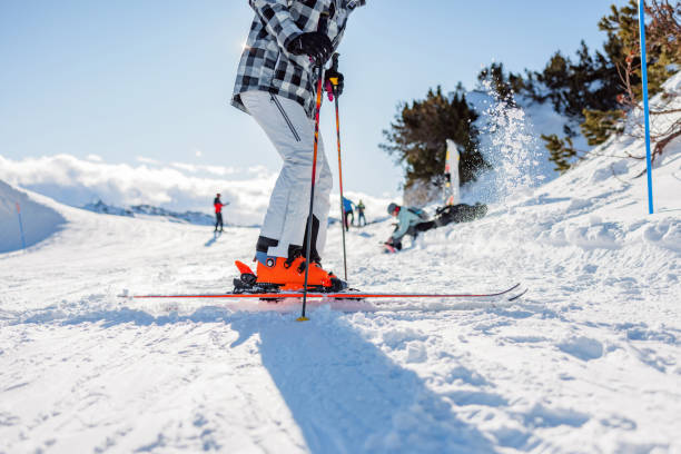 A rear view of a skier's skis, bindings and boots, as they are ready to ski down the piste.