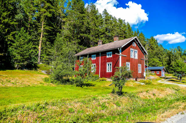 istock A red house sits in a lush green field 2193268815