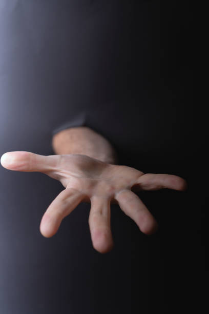 istock photo Mysterious extended hand reaching through a dark barrier, symbolizing connection, interaction, and the enigmatic crossing of physical and metaphorical boundaries 2193269623