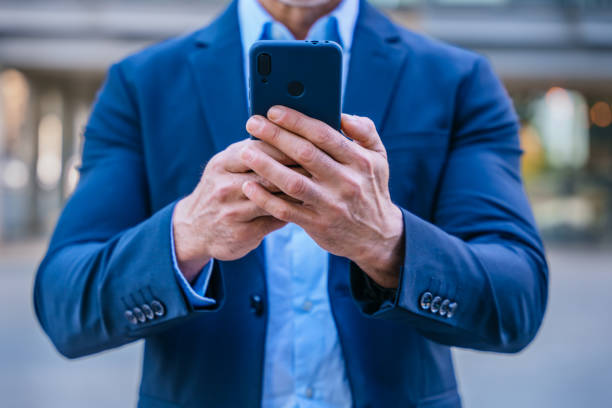 istock Unrecognizable Confident businessman using smartphone outdoors 2193273945