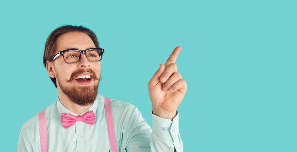 istock Cheerful funny and stylish smart guy showing ad copy place space isolated on turquoise background. 2193276470