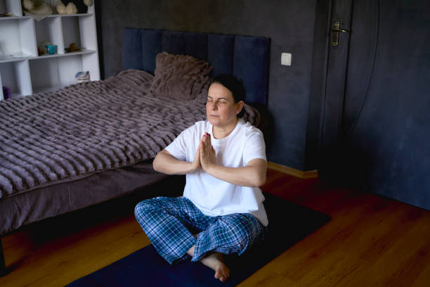istock a senior woman performs somatic exercises, yoga at home 2193277058