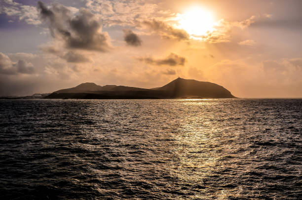 istock The sun is setting over the ocean, casting a warm glow on the water 2193279203