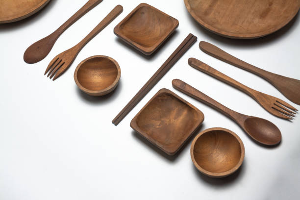 High-quality stock image of wooden kitchen utensils, including a spoon, fork, chopsticks, and a plate, displayed on a clean white background. Perfect for product branding, e-commerce, or eco-friendly kitchenware concepts.