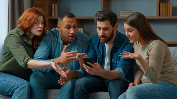 istock Disappointed sad multiracial people watching sport game streaming on mobile phone upset by lost soccer match sit on couch diverse women men friends football fans looking at cellphone lose bad result 2193284285