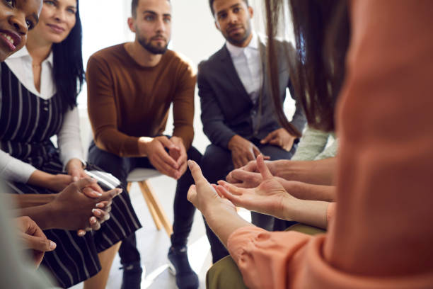 istock Different people sitting in circle during group therapy listen carefully to woman. 2193285572