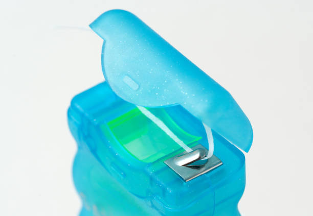 istock Macro Photography of Open Dental Floss Container with White Floss String. Oral Hygiene and Personal Care Background. 2193287194