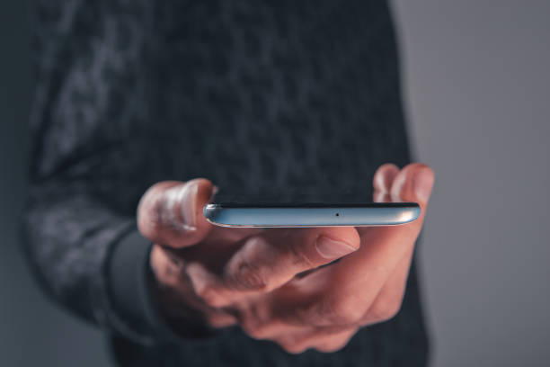 istock close up of a man using mobile phone, 2193288308