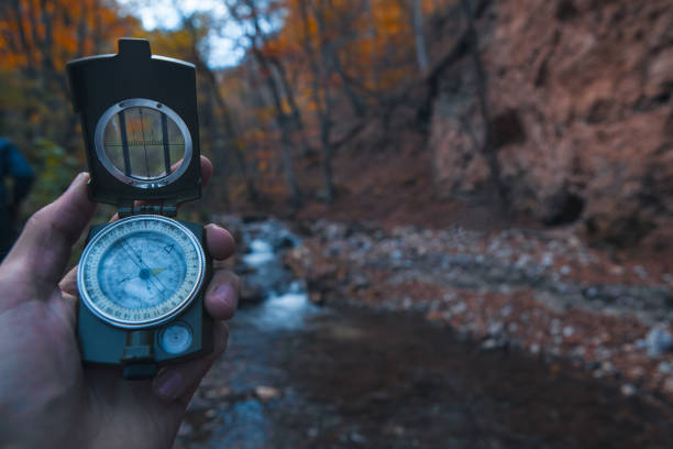 istock man hiker looking at compass on the rock in autumn 2193288317