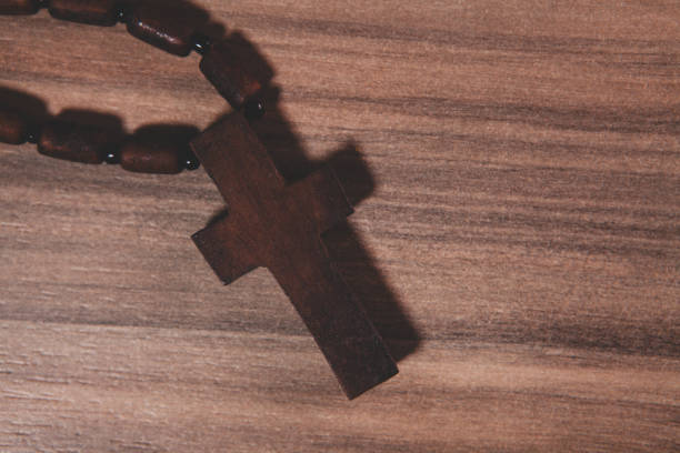rosary cross on the old wooden table,