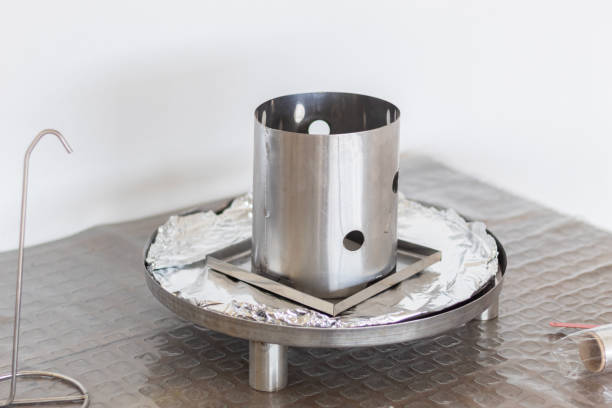 istock Smoker barrel base ready with aluminum foil and internal charcoal container. View of the initial assembly of a practical rotisserie barrel design. 2193288565