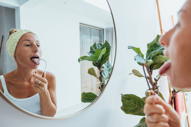 Woman Practicing Tongue Cleaning in Modern Bathroom