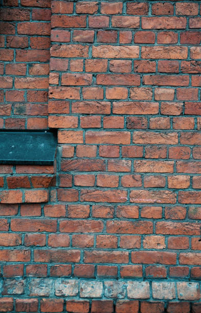 istock Weathered textures of rustic brick wall with a walled-up window and iron window sill flashing 2193291312
