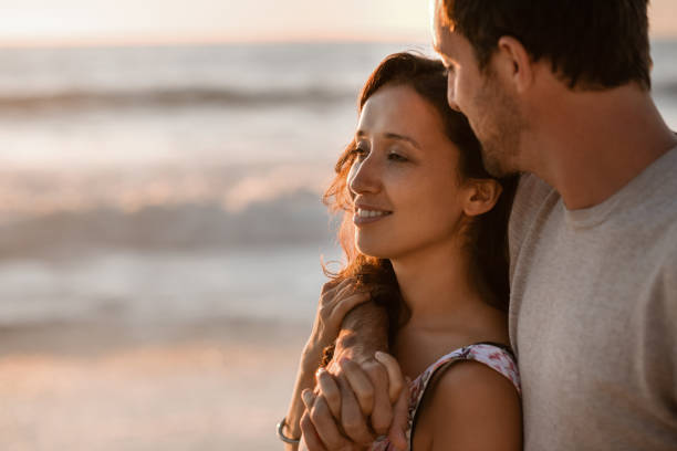 istock Loving couple standing on a beach in the late afternoon 2193291804