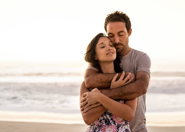 istock Loving young couple hugging on a beach at sunset 2193291855