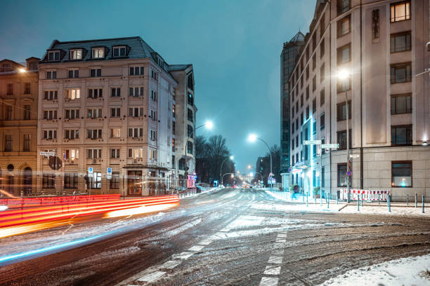long exposure of car on slippery frozen street in snowy central berlin
