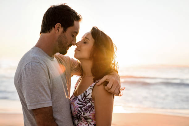 istock Loving young couple hugging on a beach at sunset 2193292279