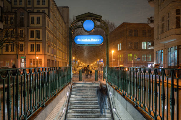 motion blurred man coming up stairs of subway station in central berlin at winter night