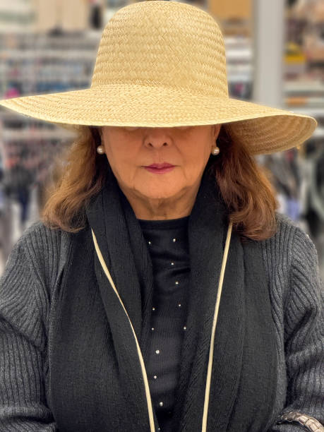 Senior Hispanic woman wearing straw sunhat