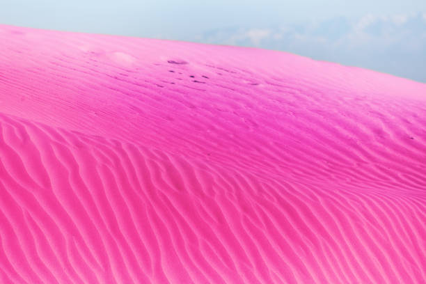 Surreal soft pink rippled sand dunes in the desert