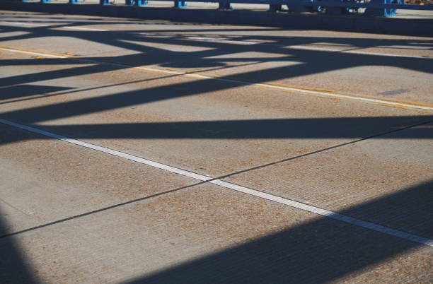 Cars drive along a clean road lined with decorative metal barriers in Morocco's urban area.