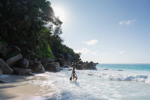 istock Young woman prepares to go snorkelling 2193295427