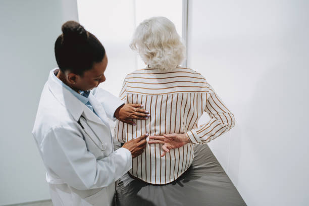 Patient with back pain Patient with back pain chiropractor stock pictures, royalty-free photos & images
