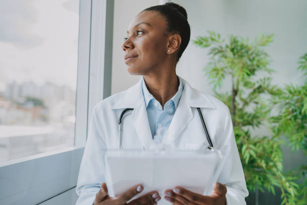istock Thoughtful doctor looking out the window in her office 2193298582