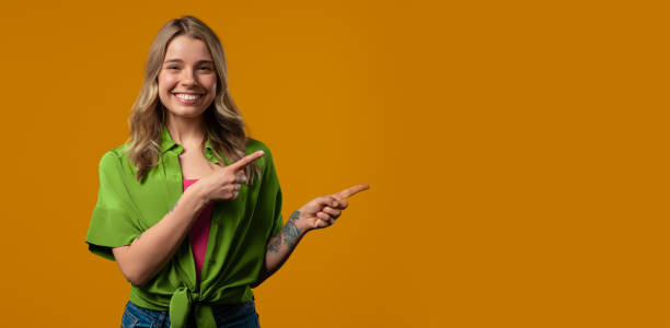 istock Recommending smiling woman pointing at right side, copy space or advertising. 2193299366